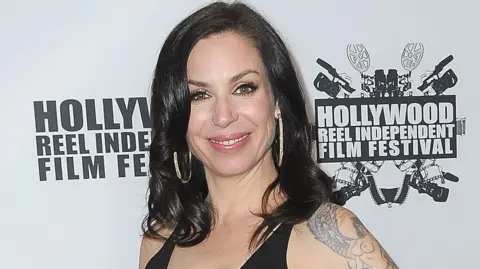 Author shot by police after backyard stand-off